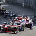 Monaco Grand Prix Travel Guide featuring Formula 1 cars racing through Monte Carlo