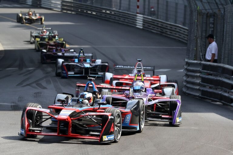 Monaco Grand Prix Travel Guide featuring Formula 1 cars racing through Monte Carlo