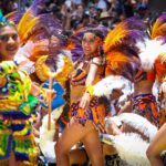 Notting Hill Carnival parade featuring colorful Caribbean costumes in London