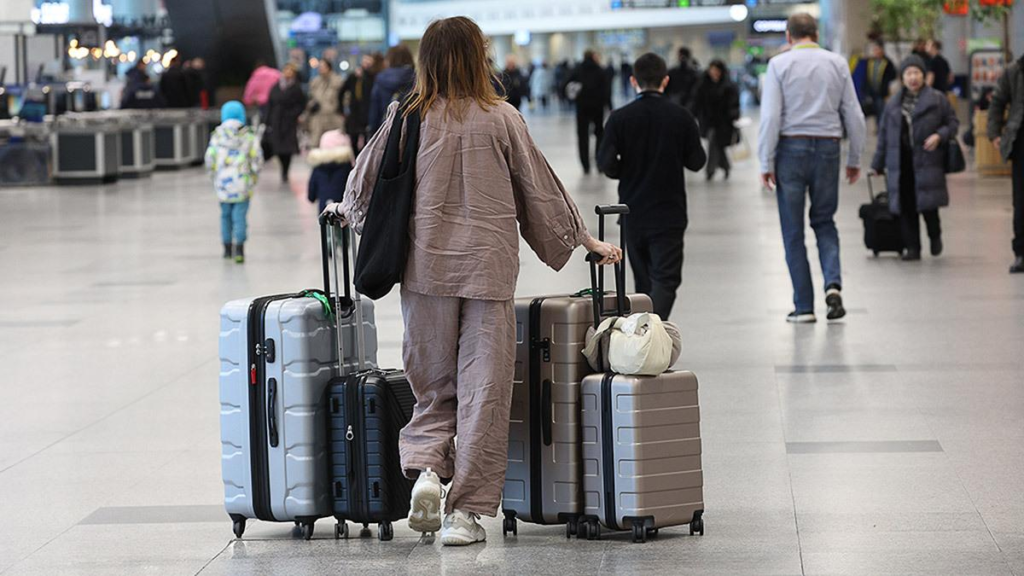 Traveler carrying luggage at airport