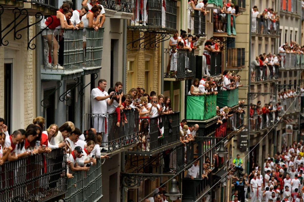 Spectators watching the Running of the Bulls from balconies